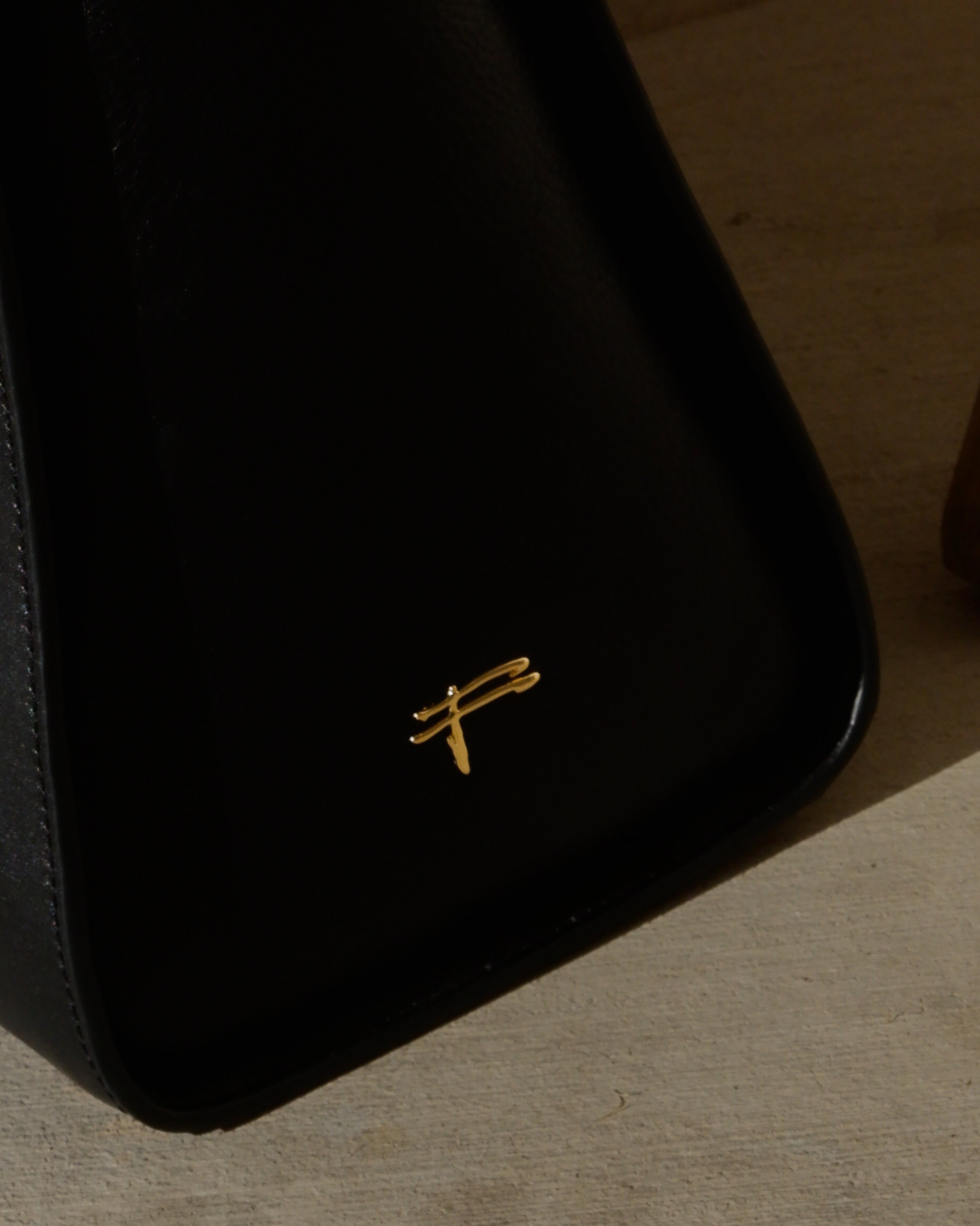 Black cowhide leather tote bag with gold hardware — the Take Me With You carryall by Felimon, designed for everyday use and timeless style.