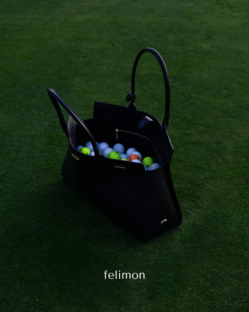 Black cowhide leather tote bag for golf with gold hardware — the Take Me With You carryall by Felimon, designed for everyday use and timeless style.