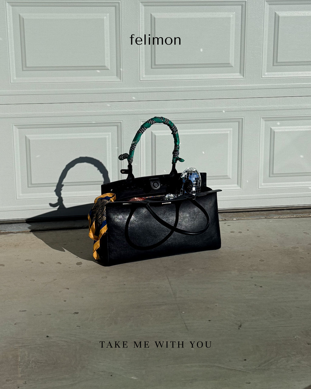 Black cowhide leather tote bag with gold hardware — the Take Me With You carryall by Felimon, designed for everyday use and timeless style.