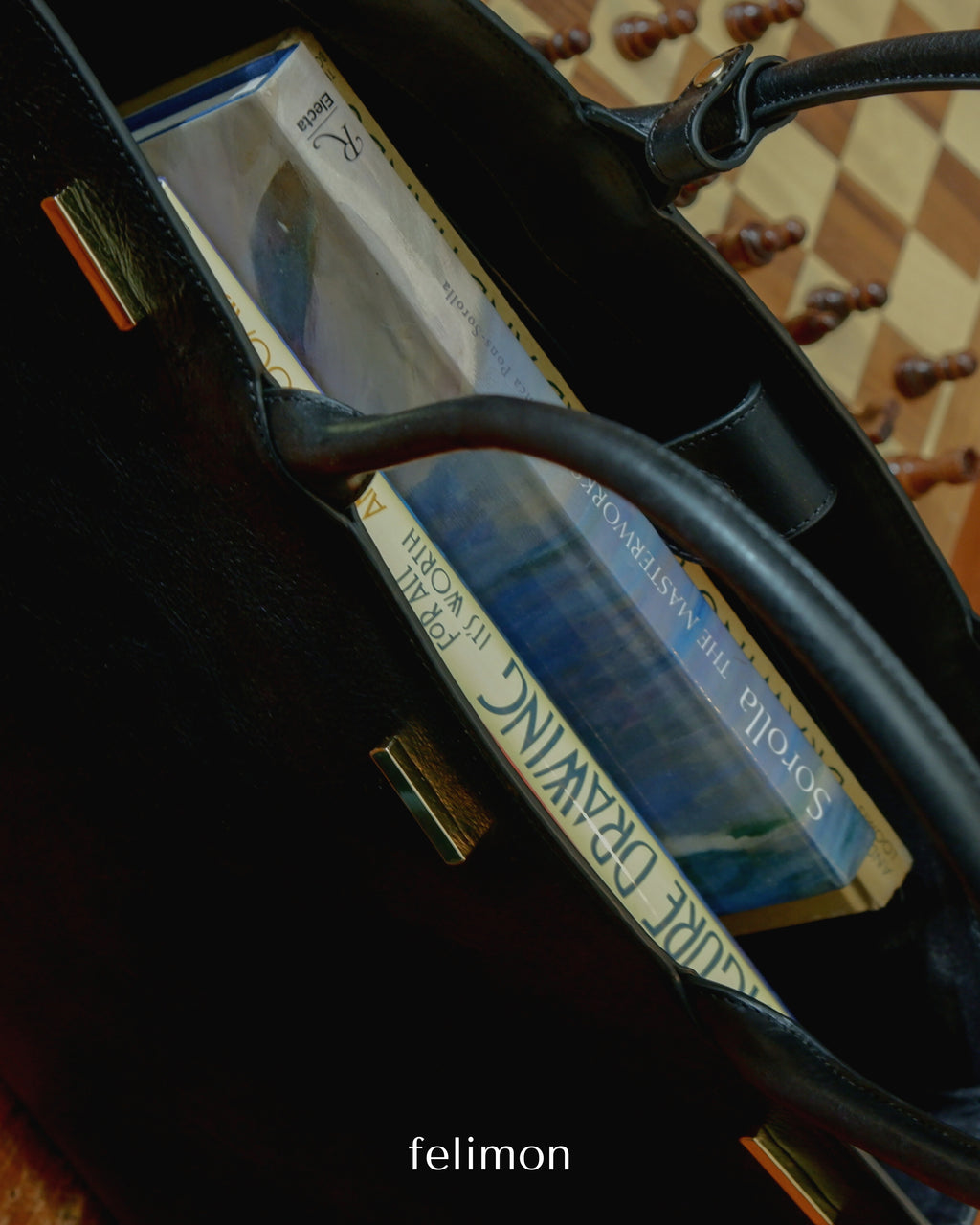 Black cowhide leather tote school and work bag with gold hardware — the Take Me With You carryall by Felimon, designed for everyday use and timeless style.