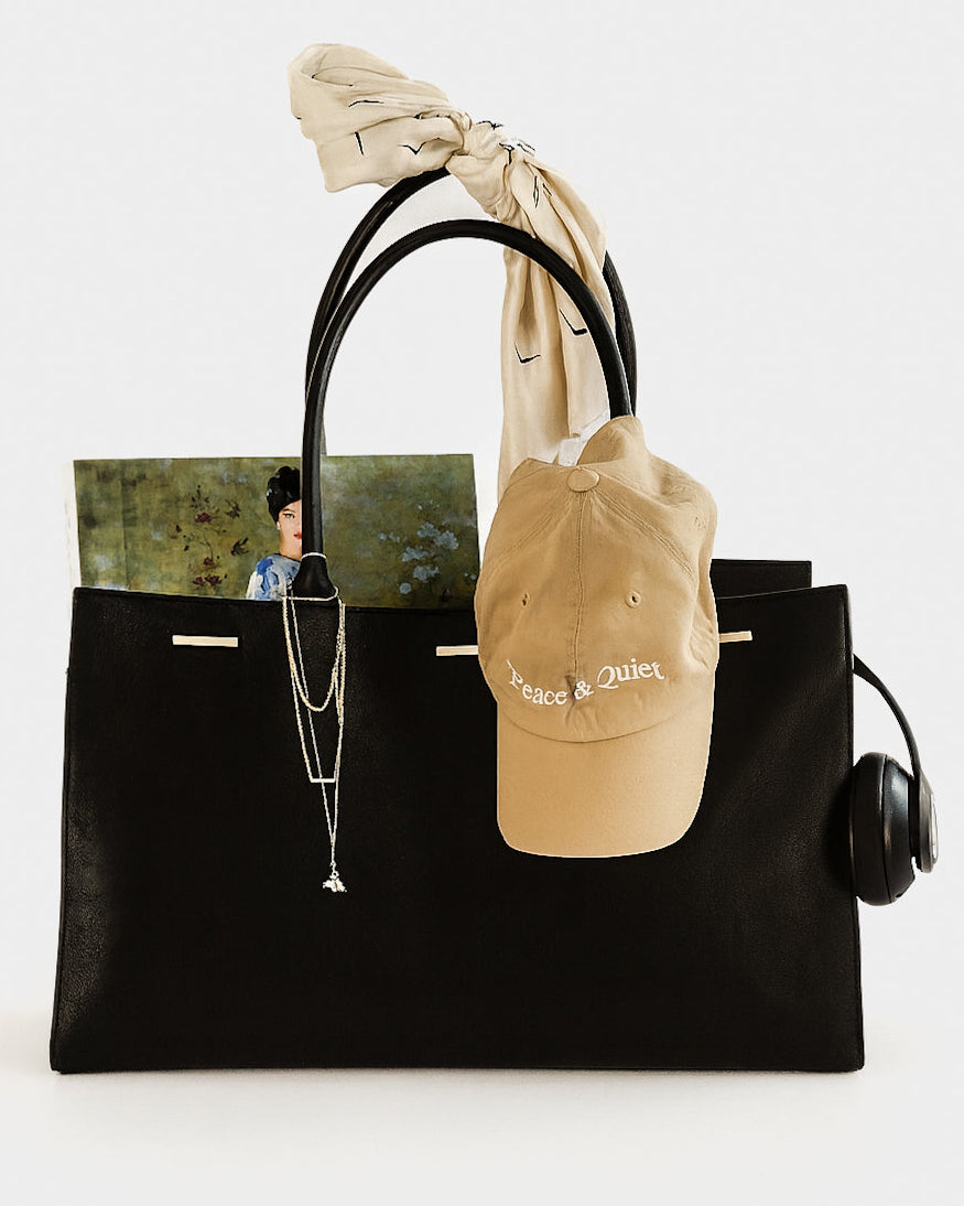 Black cowhide leather tote bag with gold hardware — the Take Me With You carryall by Felimon, designed for everyday use and timeless style.