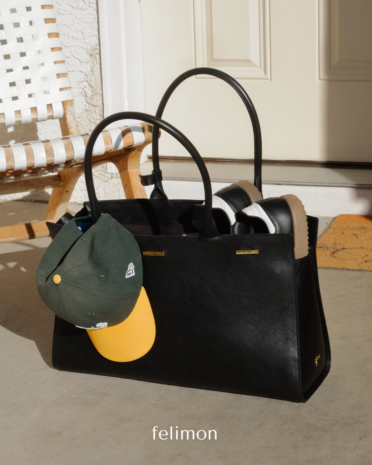 Black cowhide leather tote bag with gold hardware — the Take Me With You carryall by Felimon, designed for everyday use and timeless style.