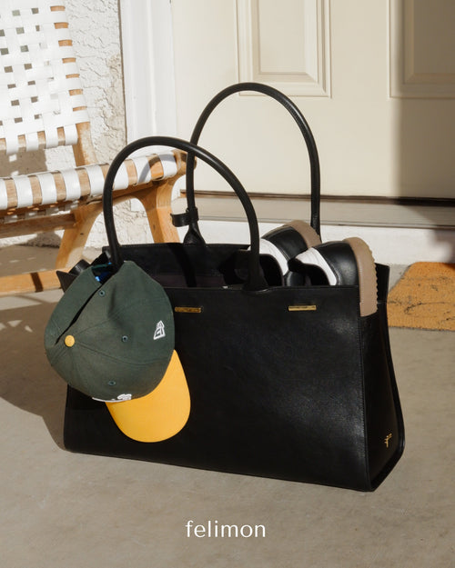 Black cowhide leather tote bag with gold hardware — the Take Me With You carryall by Felimon, designed for everyday use and timeless style.