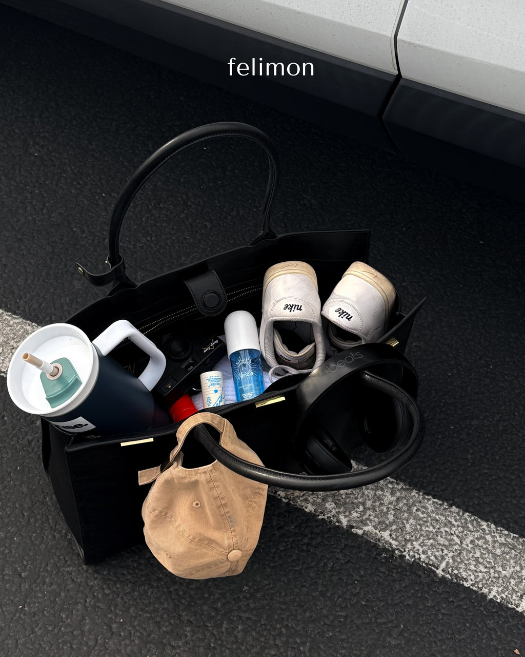 Black cowhide leather tote bag with gold hardware — the Take Me With You carryall by Felimon, designed for everyday use and timeless style.