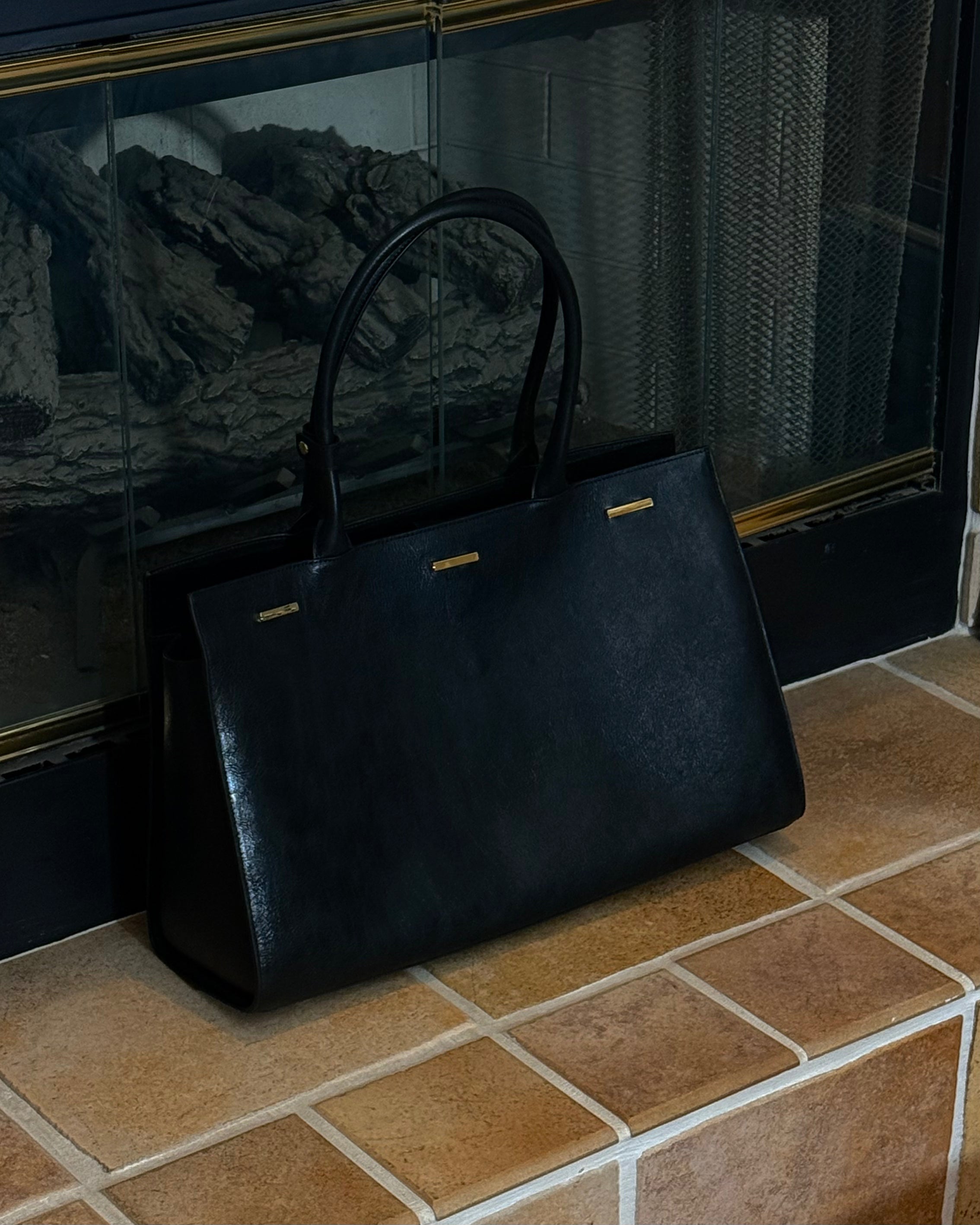 Black cowhide leather tote bag with gold hardware — the Take Me With You carryall by Felimon, designed for everyday use and timeless style.